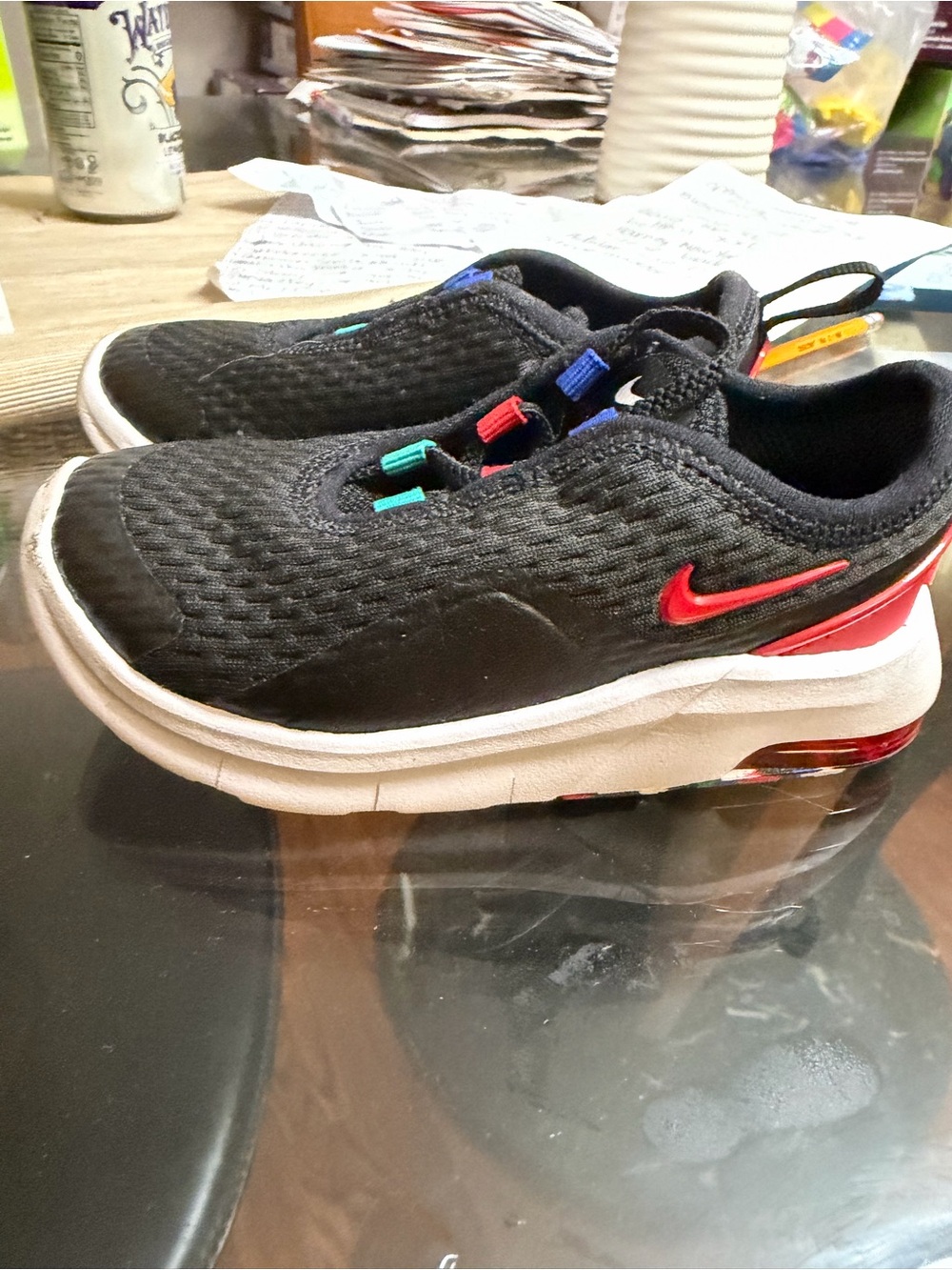 Nike Kids Black Slip-On Sneakers with Red Swoosh and Colorful Accents
